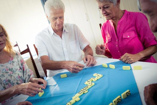 Group of seniors playing dominoes