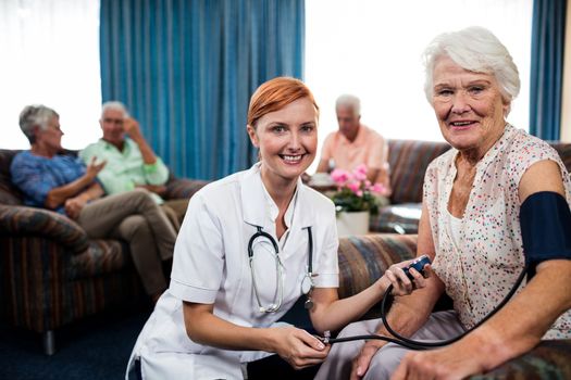 Nurse taking care of pensioner 