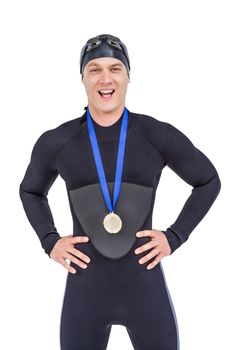Victorious swimmer posing with gold medal around his neck