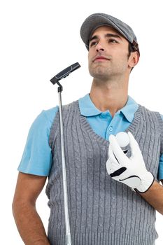Golf player standing with golf ball and golf club