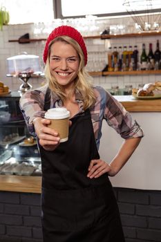 Waitress showing a disposable cup