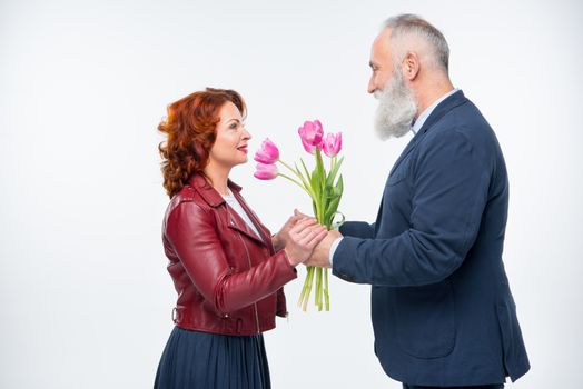Man presenting flowers to woman  