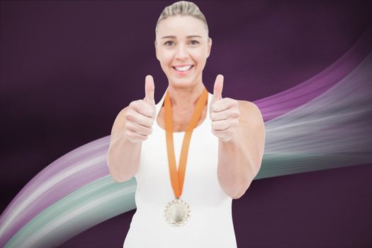 Composite image of female athlete wearing a medal and showing thumbs up