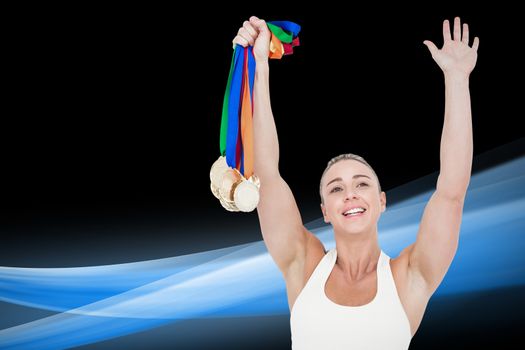 Composite image of happy female athlete holding medals