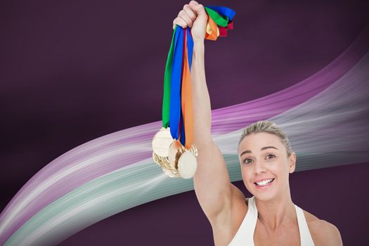 Composite image of happy female athlete holding medals