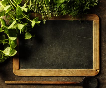 Blank chalkboard with herbs. 