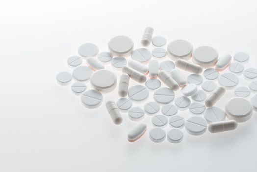 Close-up view of medical pills and capsules on white, medicine and healthcare concept      