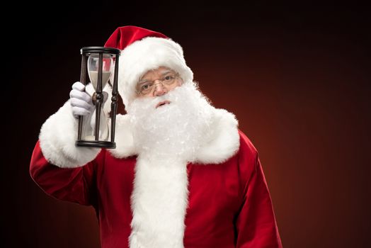 Santa Claus showing hourglass  