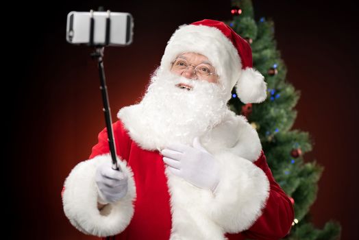Happy Santa Claus taking selfie  