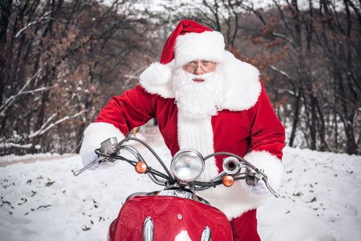 Santa Claus riding on scooter