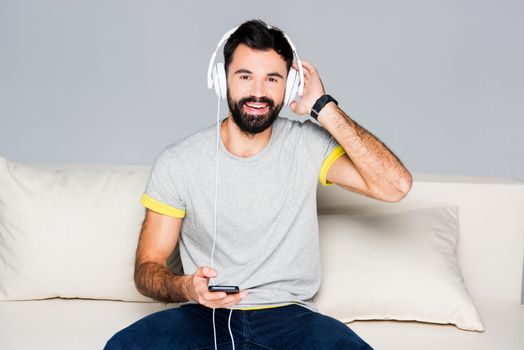 Bearded man in white headphones