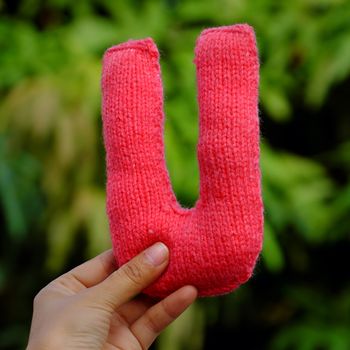 Woman hand pick knitted alphabet
