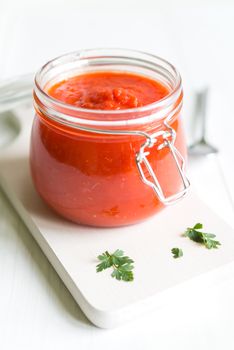 Tomato Sauce In Jar On White Wooden Table