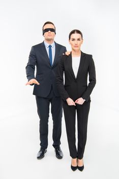 Businessman in blindfold and businesswoman