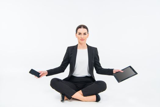Businesswoman sitting with devices
