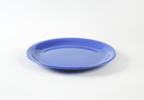Coupe shaped blue ceramic plate
