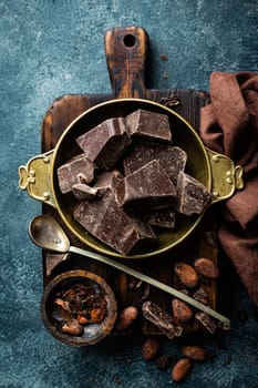 Dark chocolate pieces crushed and cocoa beans, top view