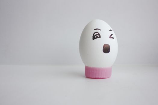 Egg cheerful with a face alone concept of yawn