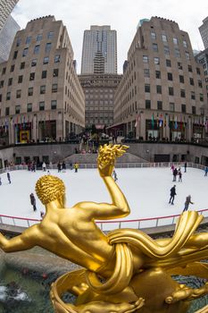 Golden Prometheus statue and Rockefeller Center ice skate rink, Manhattan, New York City, USA.