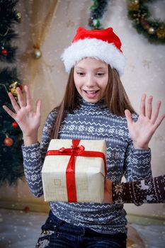 Surprised girl receiving Christmas gift