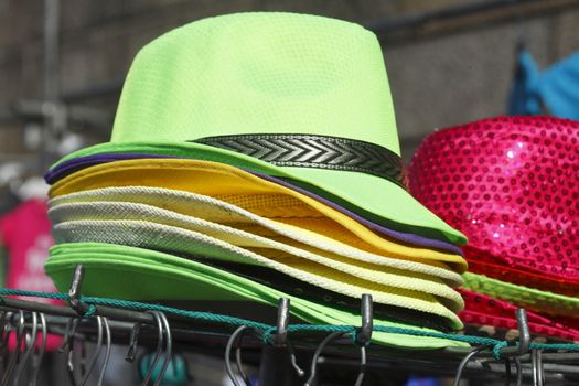 staked green Hats on a market stall
