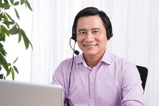 Portrait of handsome asian hotline person consultant wearing hea
