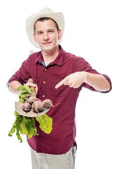 Gardener farmer laid on a spade of a beet crop, portrait on a white background