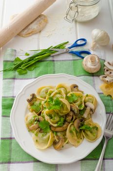 Homemade tortellini with mushrooms and herbs