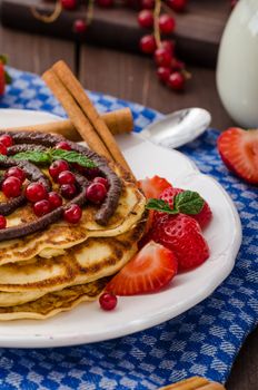 Cinnamon pancakes with chocolate sauce and berries