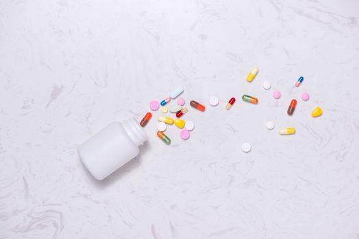 Colored pills with bottle  on table. Flat lay.