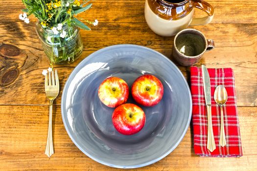 Place Setting With Apples, Flowers and Crockery