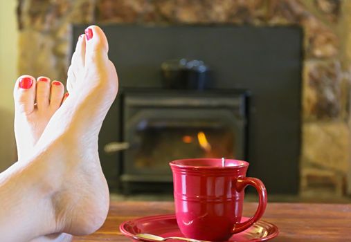 Feet Resting by the Fire With a Cup of Tea