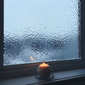 Frosted window and candle light