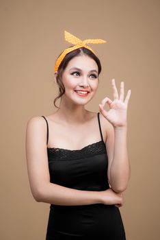 Beautiful woman pinup style portrait. Asian woman hands gesture
