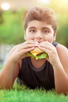 Teen boy eating burger