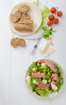 Arugula salad with meat and mozzarella