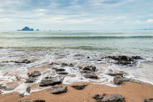 Sea foam of the Andaman Sea and rocks on the shore, beautiful sc