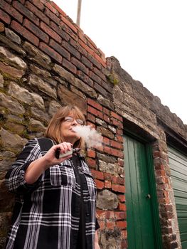 Mature Woman Smoking an Electronic Cigarette 