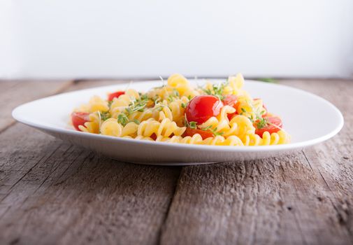 Fussili pasta with watercress and cherry tomatoes.