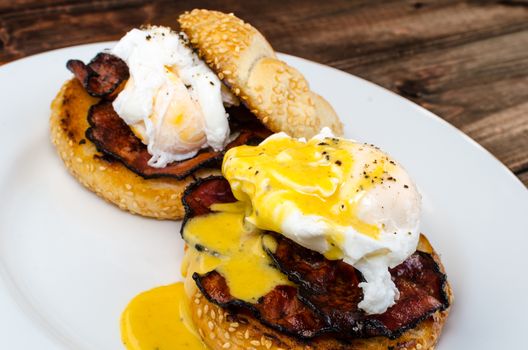 Benedict eggs with crispy bacon and hollandaise sauce on toasted Maffin
