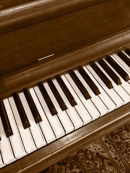Chocolate color classical piano. Retro style photo.