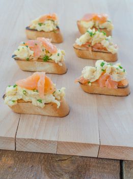 Toast with smoked salmon with scrambled eggs