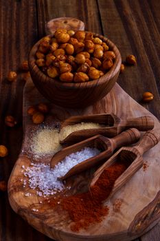 Roasted spicy chickpeas on rustic background