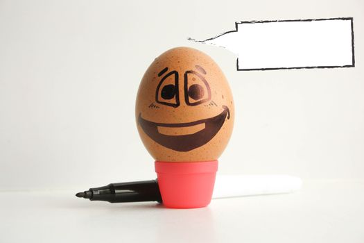 Egg with a cheerful painted face. Photo