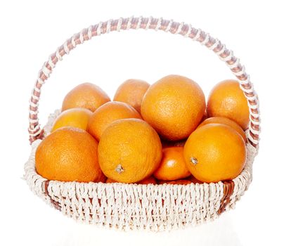 Lots of oranges in fruits basket isolated on white background