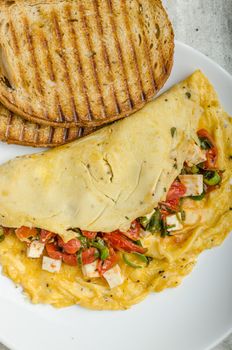 Mediterranean-Style Omlette with crispy garlic bread and apple juice, feta cheese, spring onion filling