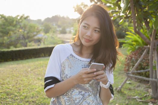 asian younger woman with smartphone in hand happiness thinking ,
