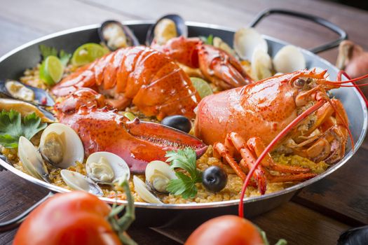 Paella with fresh lobster, clams, mussels and squid