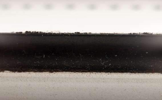 close up texture macro background of black strip through white background; UK