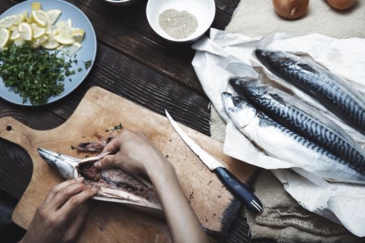 Woman preparing mackerel fish